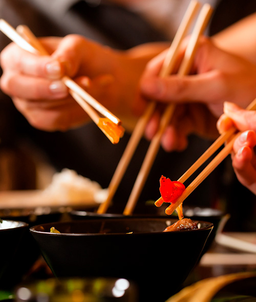 Sharing Asian cuisine with chopsticks